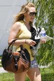Hilary Duff leggy in shorts showing black bra wiht see-through yellow top in Los Angeles